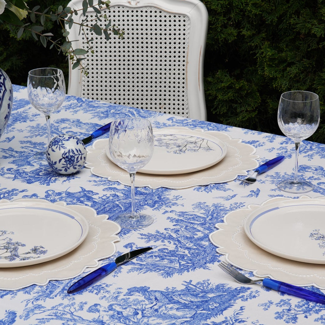 Garden party table setting featuring a blue toile table linen, perfect for summer entertaining and outdoor celebrations