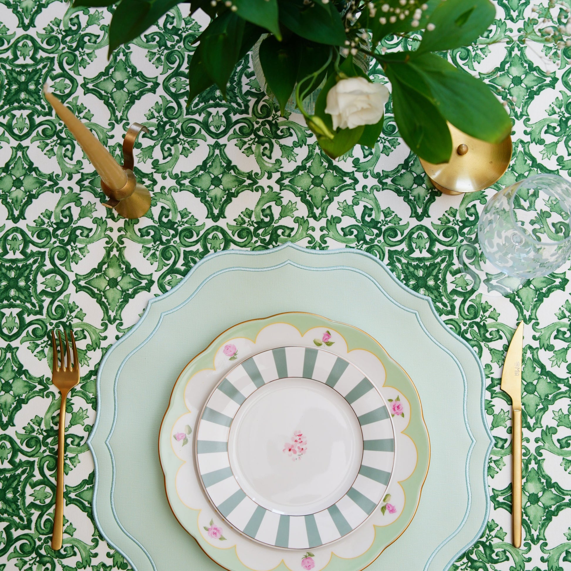 Green and white patterned rectangular tablecloth in a bright dining setting, perfect for gatherings and celebrations
