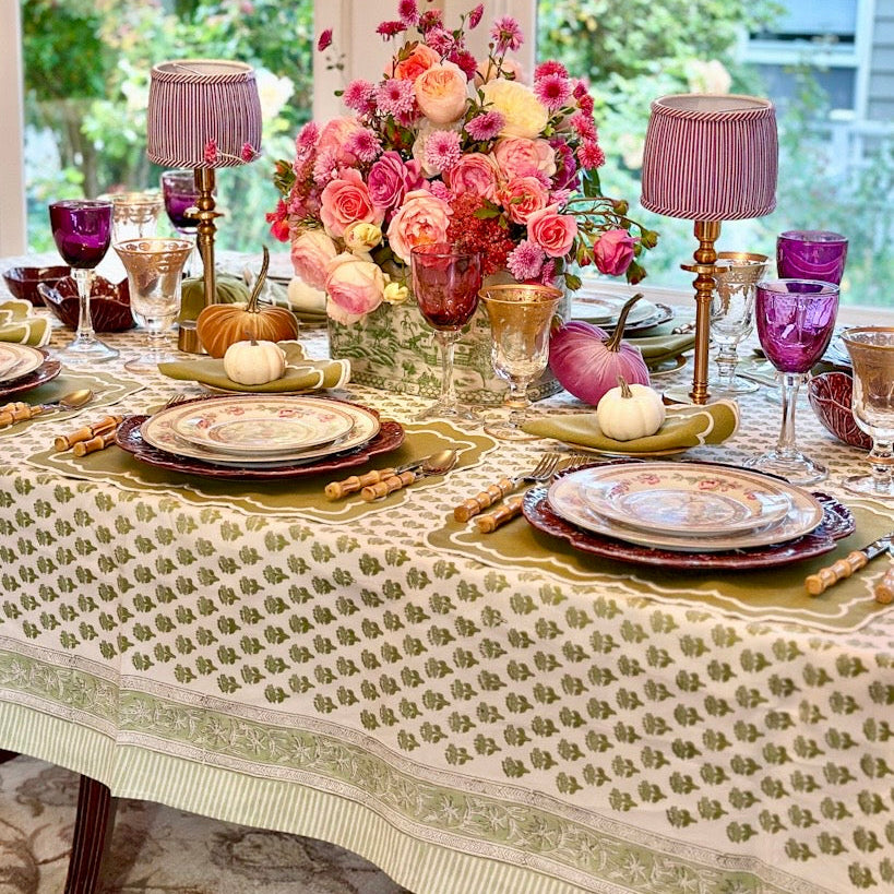 Green and white embroidered placemat with floral detail, perfect for chic table settings and everyday elegance.
