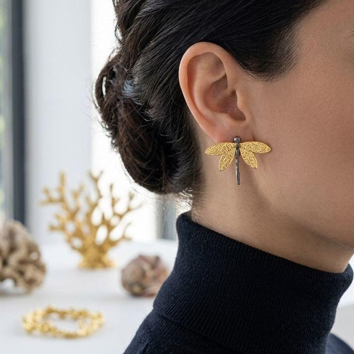 Close-up of the delicate, organic wing texture on the gold-plated dragonfly earrings, highlighting the artisan craftsmanship and nature-inspired design.