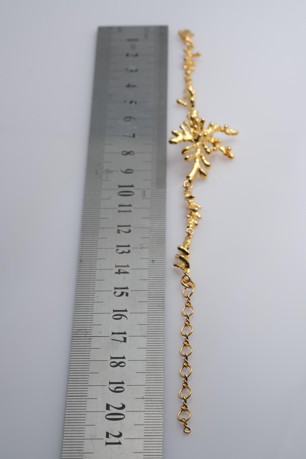 Close-up view of the detailed organic texture on the gold-plated silver pine branch bracelet, showcasing the intricate knots of real nature casting.