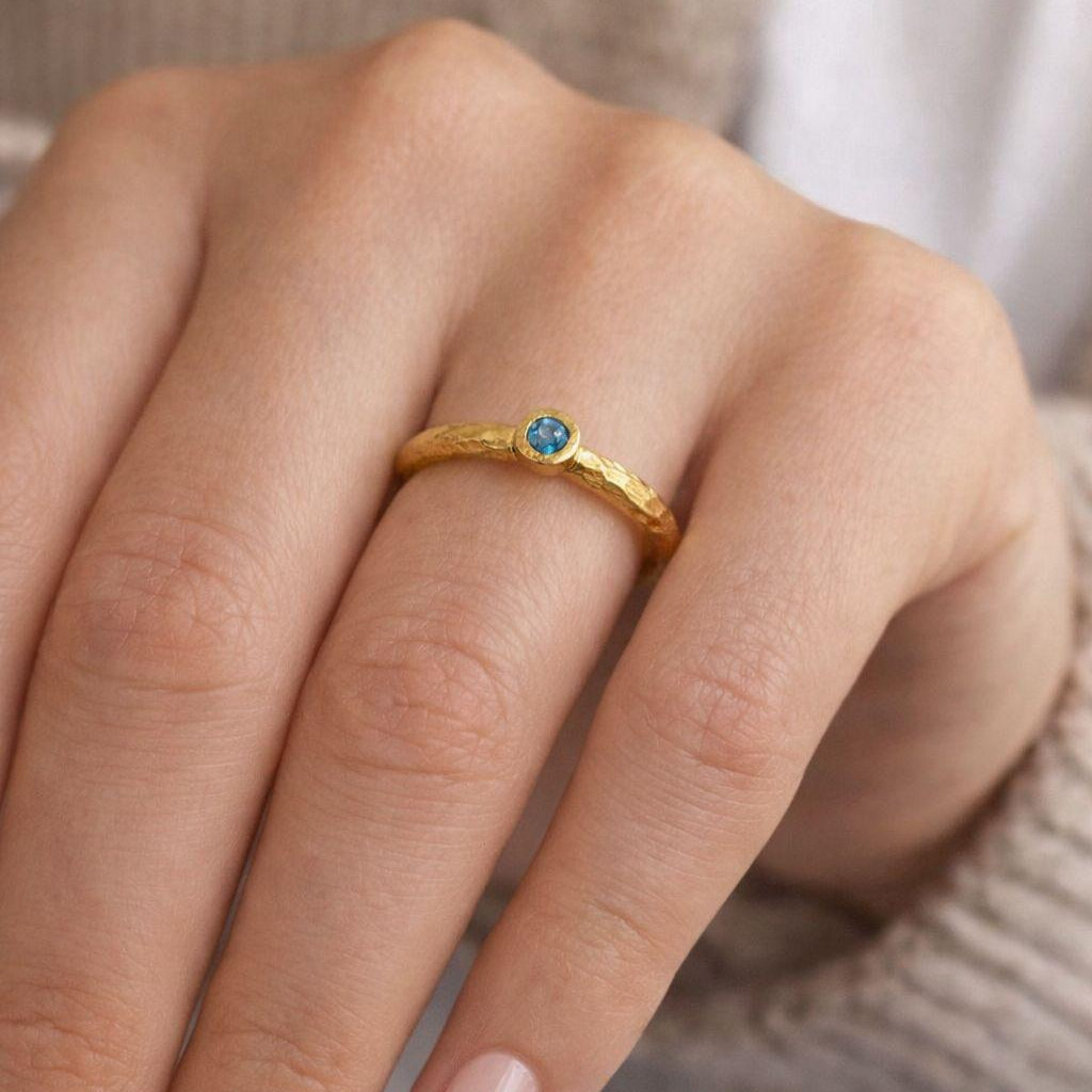 Minimalist and elegant, this artisan-made gold-plated silver ring showcases a rustic texture, making it the perfect dainty gemstone stacking ring for everyday wear.