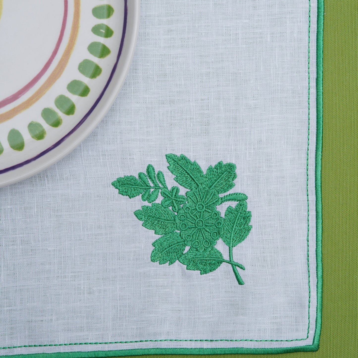 Elegant square fabric placemat presented in a modern table setting
