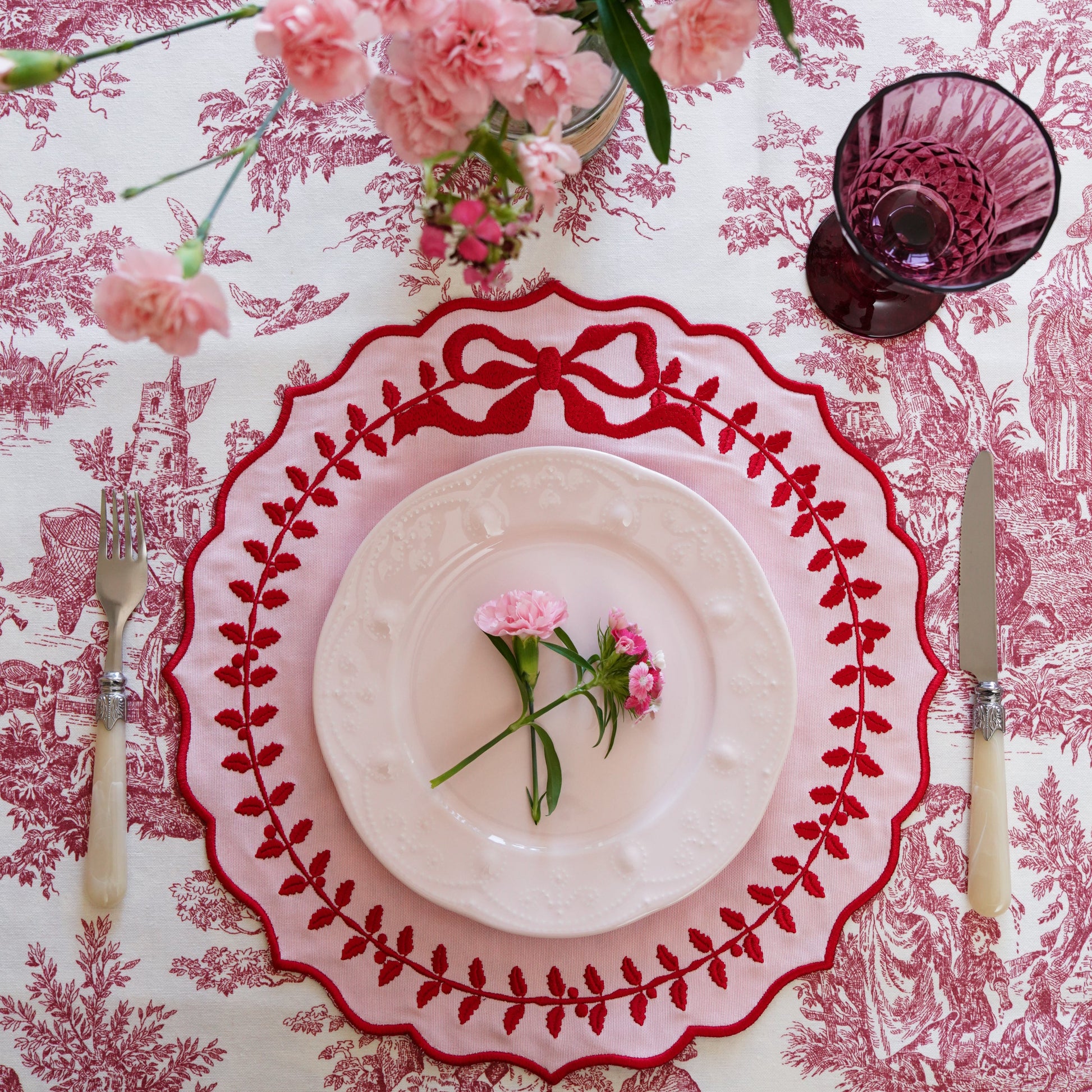 Close-up of the Champagne Pink embroidered placemat showing intricate scalloped silk-thread details and smooth cotton blend texture, emphasizing quality craftsmanship and soft pink color tones.