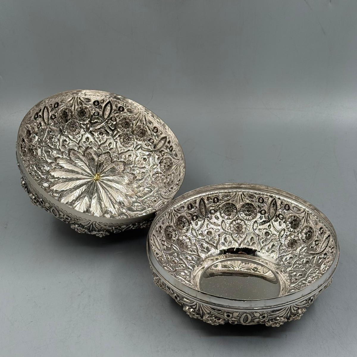 Interior view of the 1070g solid silver bonbonniere showing the intricate hand-hammered floral patterns and hinge work.