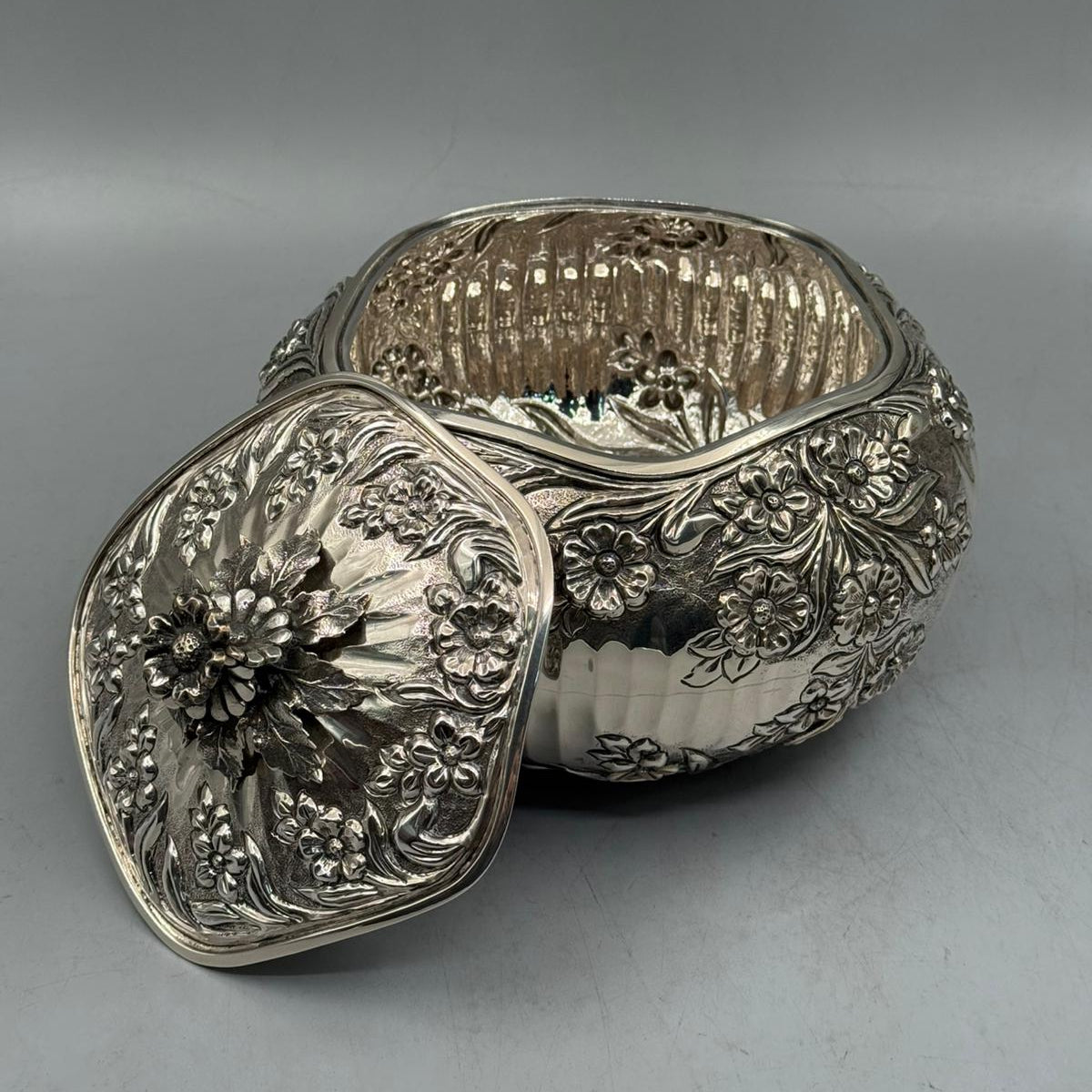 Interior view of the 978g solid silver floral bonbonniere showing the high-polish interior and lid craftsmanship.