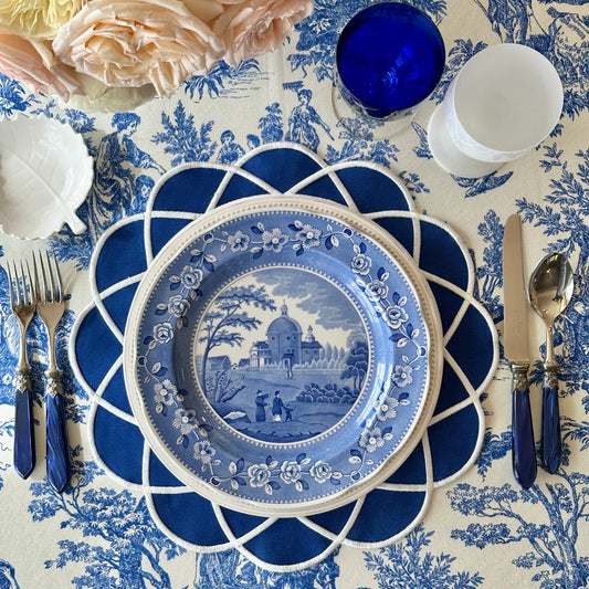 High-end spring dining decor featuring the navy blue fabric placemat with a stain-resistant finish