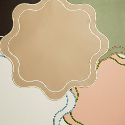 Elegant spring tablescape close-up highlighting the smooth texture and wavy edge of the Haven white vegan leather placemat