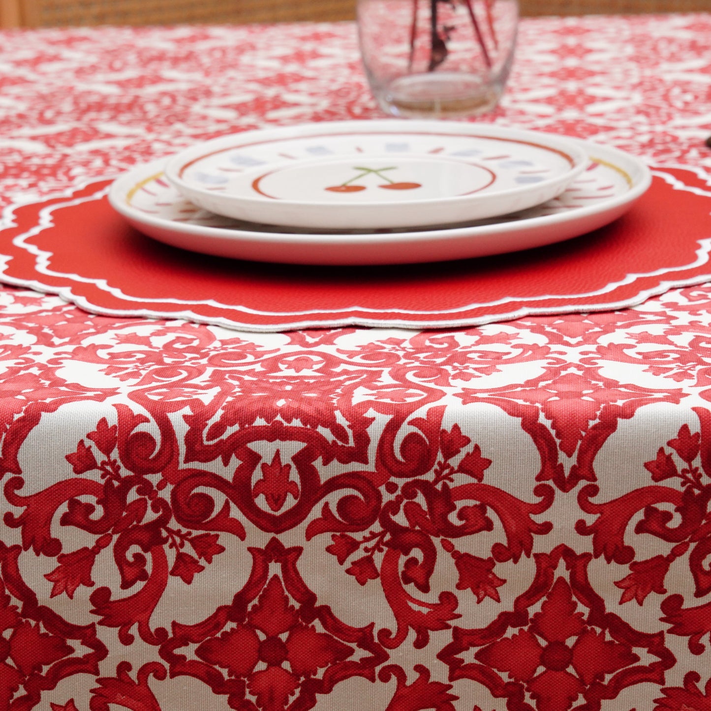 Top view of a red damask tablecloth with classic ornamental design, ideal for holiday tables and celebrations