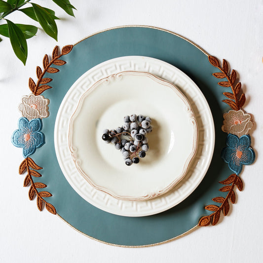 Jasmine Blue Round Faux Leather Placemat – expertly handcrafted from eco-friendly, vegan faux leather with elegant embroidery and double-layered design, stain-resistant and durable. Exclusively by PNR Decor.
