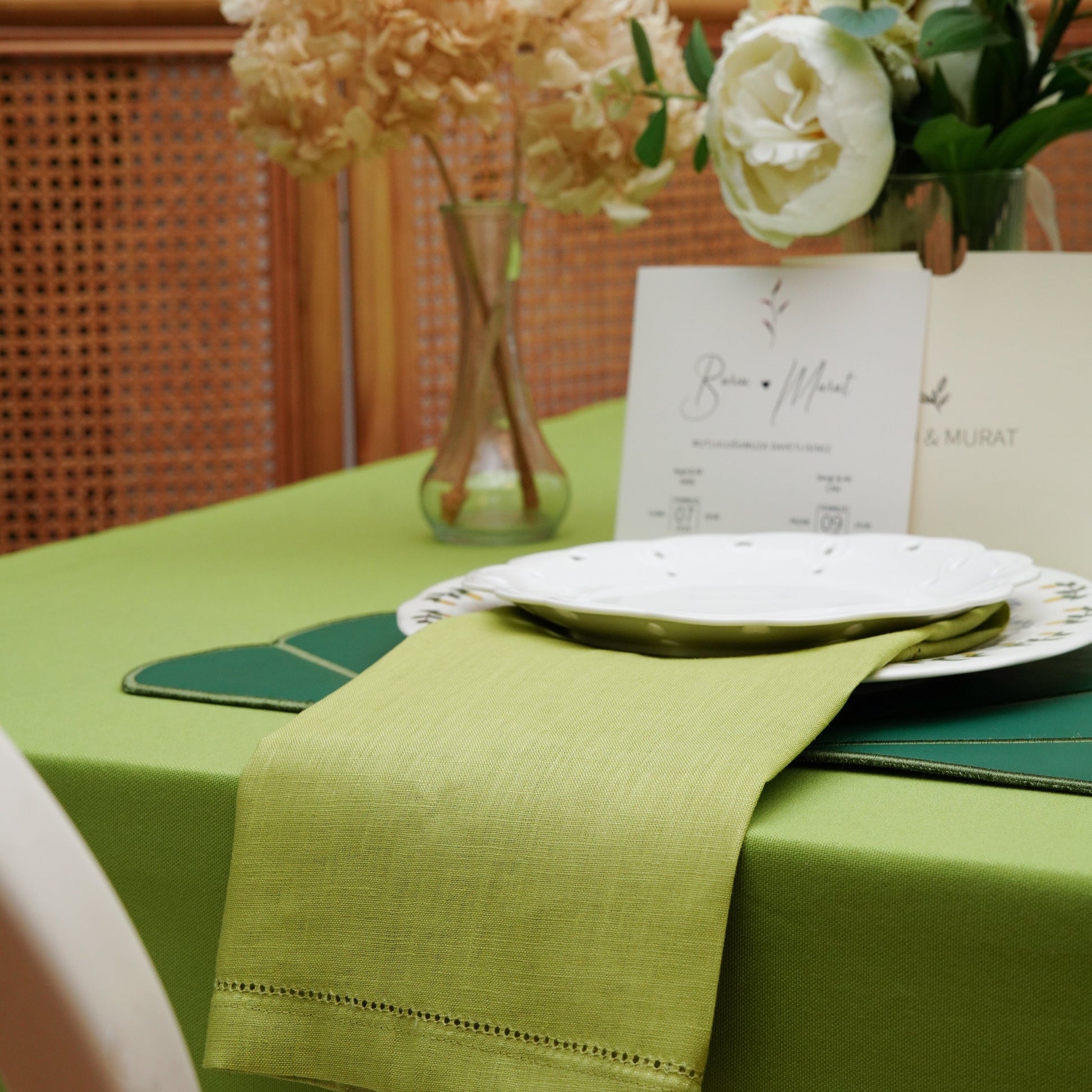 Minimal tablescape on a light green tablecloth, perfect for fresh spring and summer dining decor