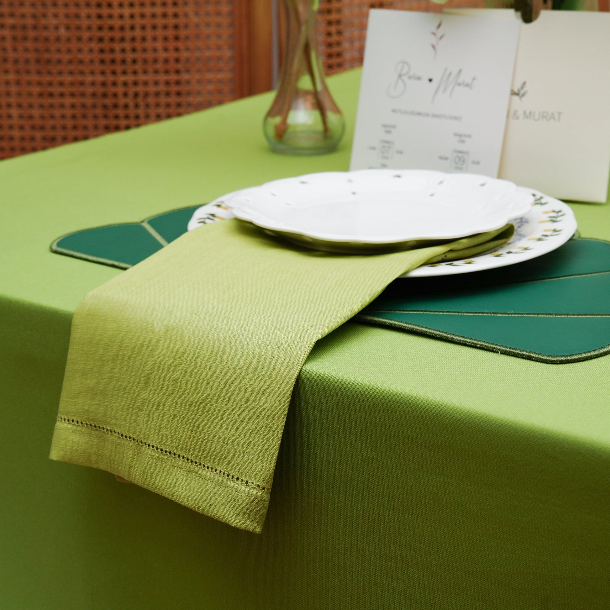 Close-up of the lime green tablecloth showing a clean solid finish and subtle woven fabric texture