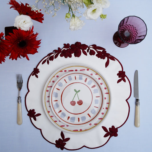 Burgundy and white faux leather placemat styled for a wedding table