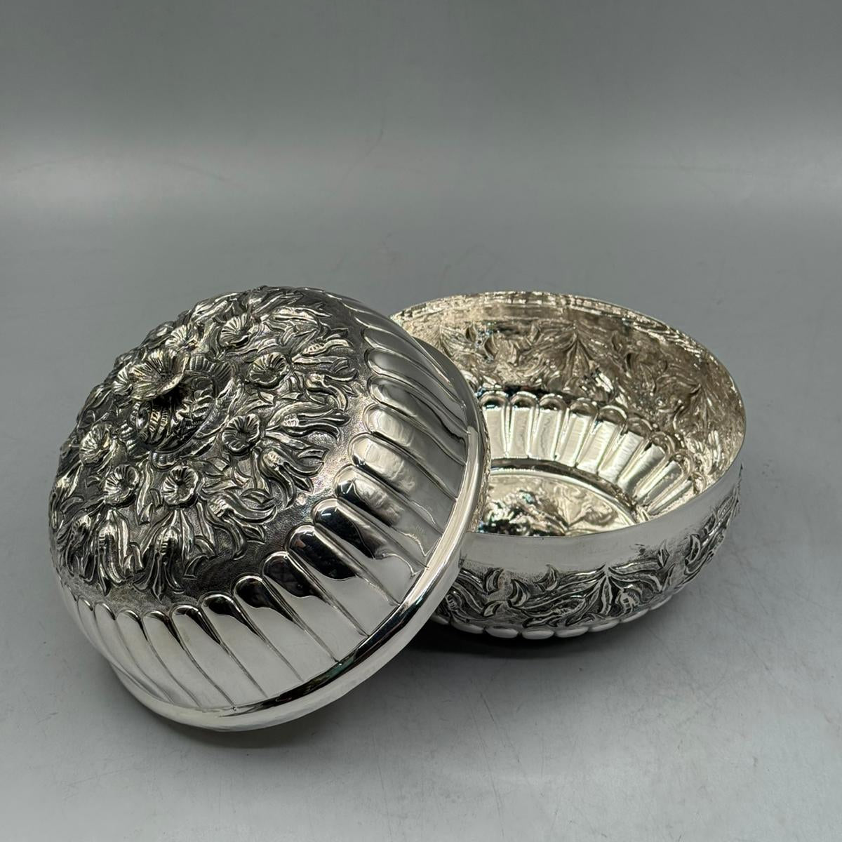 High-polish interior and detailed lid engraving of a luxury 900 sterling silver statement piece for home decor.