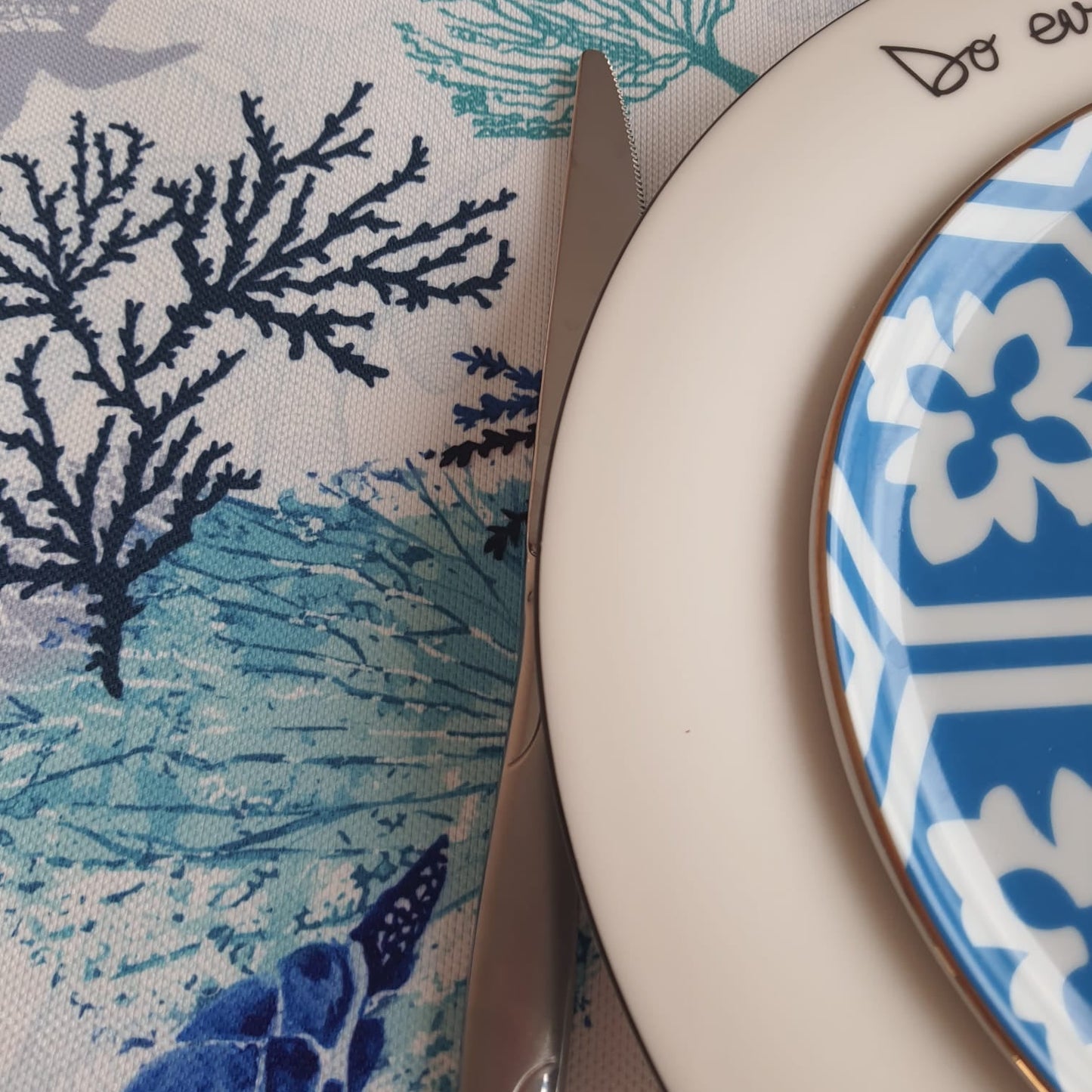 Marine life print tablecloth detail showing sea turtles, coral silhouettes, and textured fabric weave