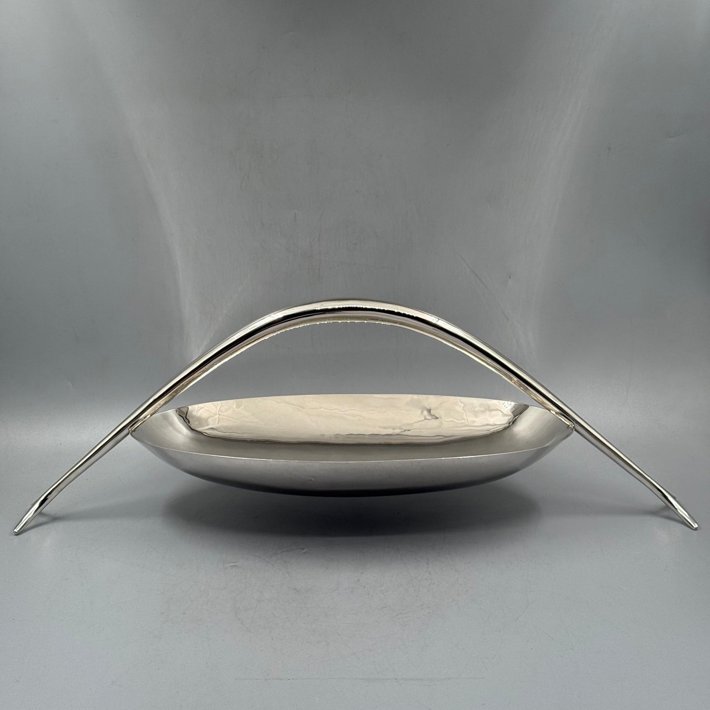 Front view of modernist silver basket with high arch handle by PNR Decor ship from USA