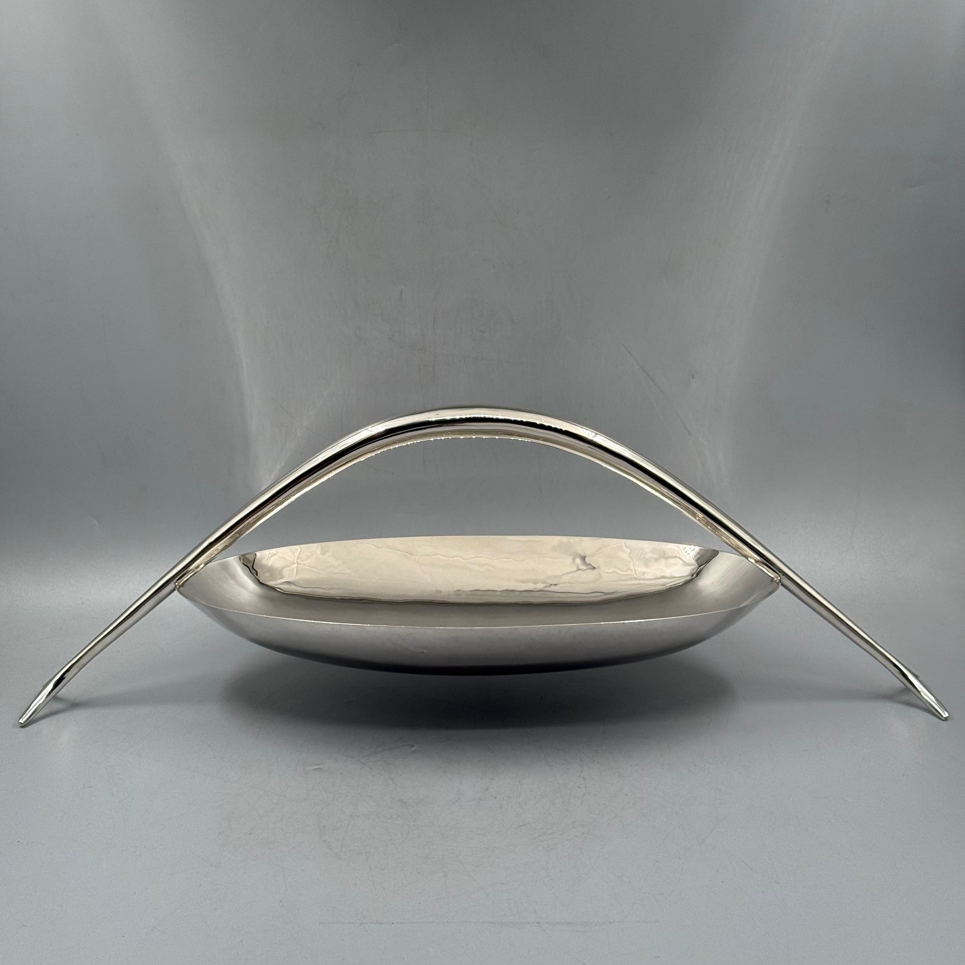 Front view of modernist silver basket with high arch handle by PNR Decor ship from USA