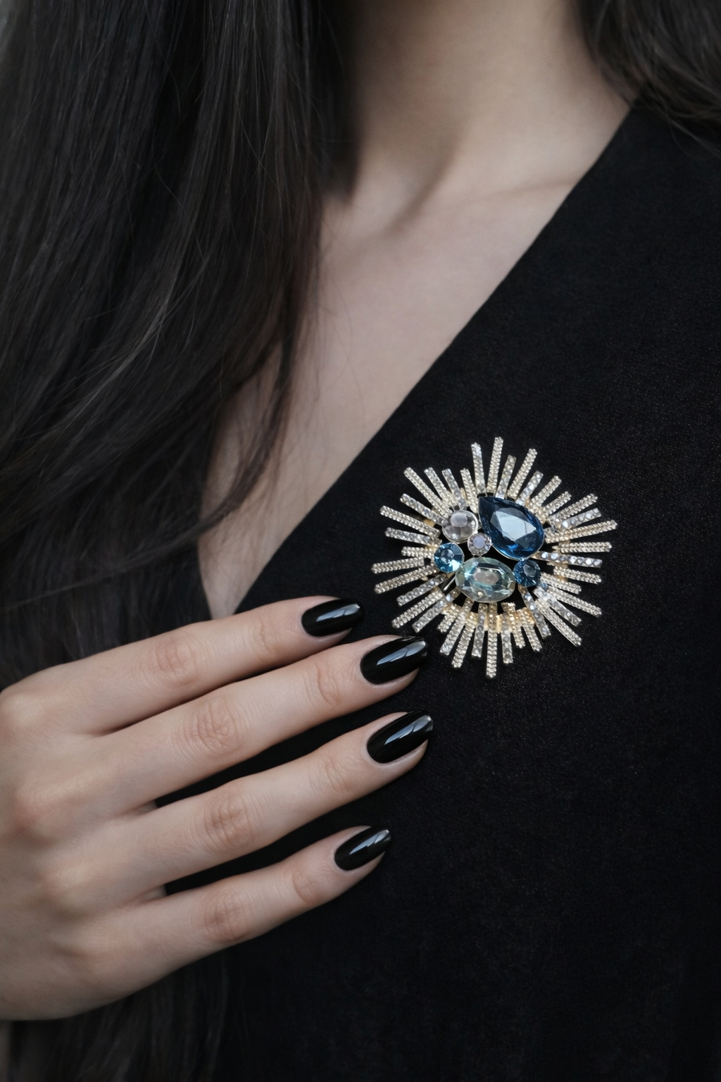 An exquisite gold-plated brooch in the shape of a traditional oriental fan, decorated with delicate pink enamel cherry blossom branches and finished with a small hanging white pearl drop.