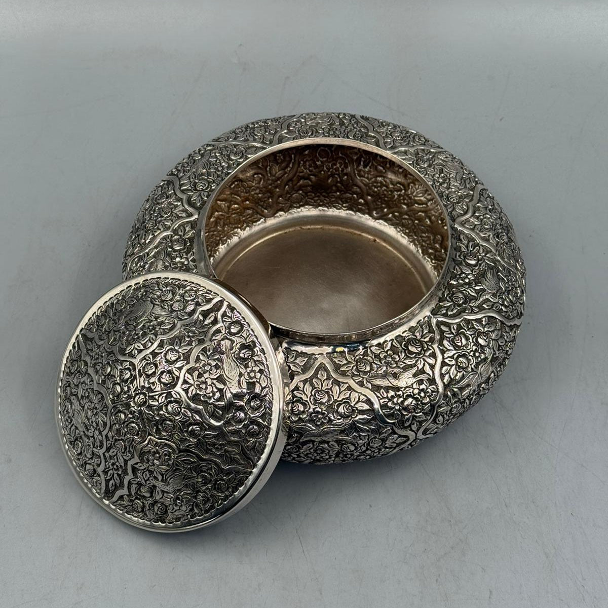 Close-up of the oxidized inlaid texture and bird motifs on the handcrafted 800 silver candy dish.