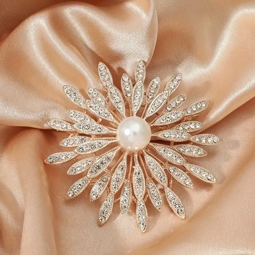 Close up of elegant pearl center crystal sunburst flower brooch on satin fabric by PNR Decor ship from USA