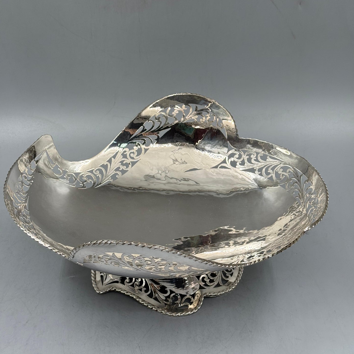 Detail of intricate openwork scroll patterns on silver centerpiece by PNR Decor ship from USA