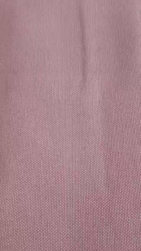 Close-up of the blush pink table linen showing a subtle woven texture and smooth solid finish
