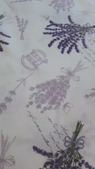 Purple lavender rectangular tablecloth draped over the table edge, highlighting the print and neat hem