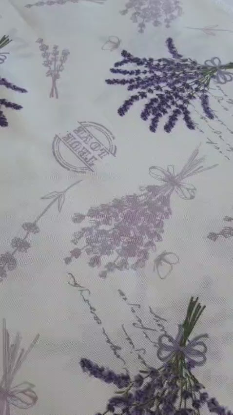 Purple lavender rectangular tablecloth draped over the table edge, highlighting the print and neat hem