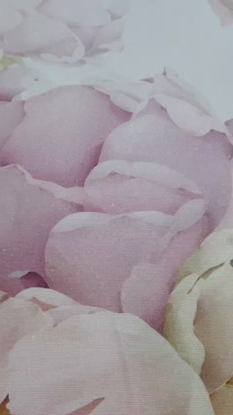 Romantic pastel floral tablecloth fabric close-up with oversized peony blooms on a light background