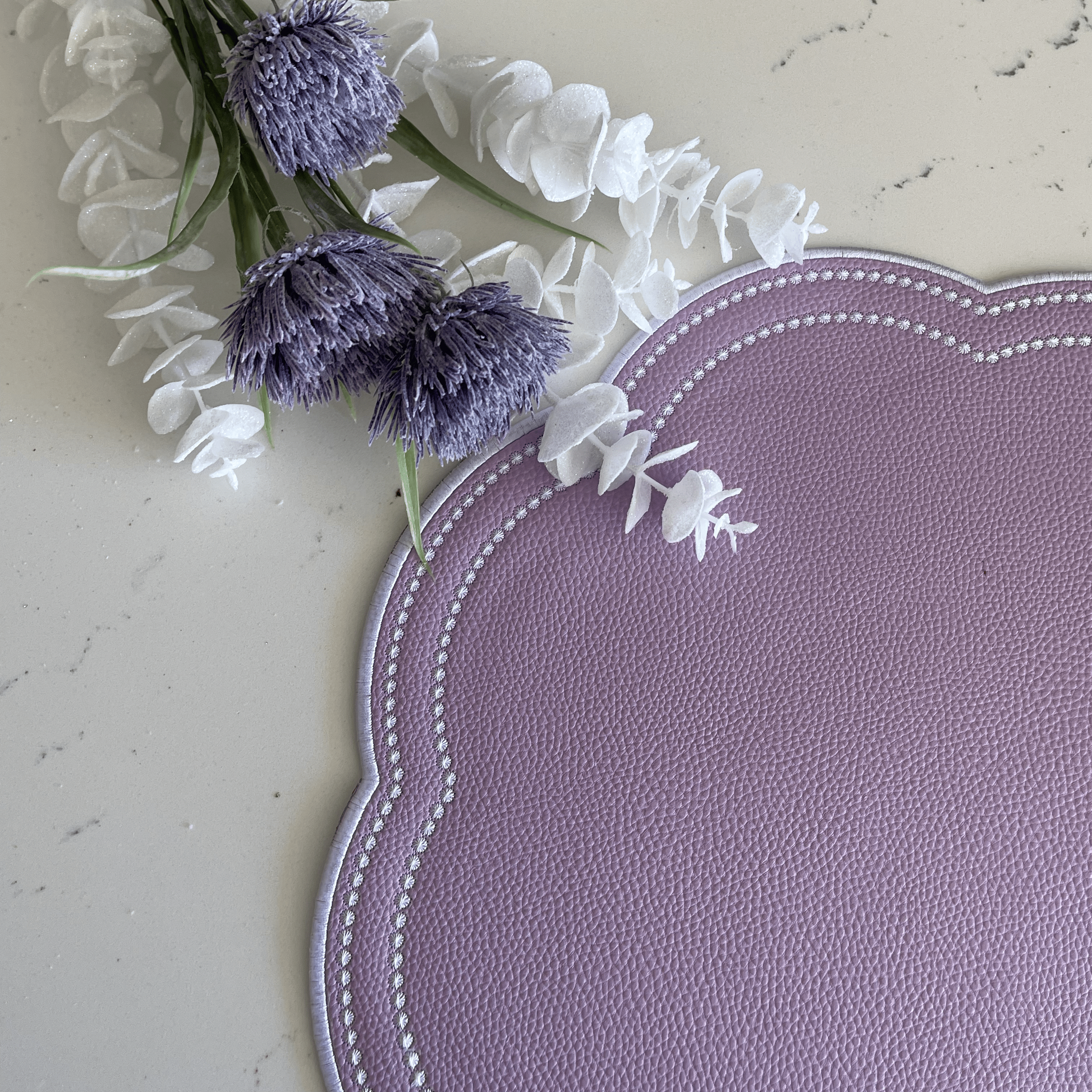 Nurture Purple Round Faux Leather Placemat – expertly handcrafted from eco-friendly, vegan faux leather with elegant embroidery and double-layered design, stain-resistant and durable. Exclusively by PNR Decor.