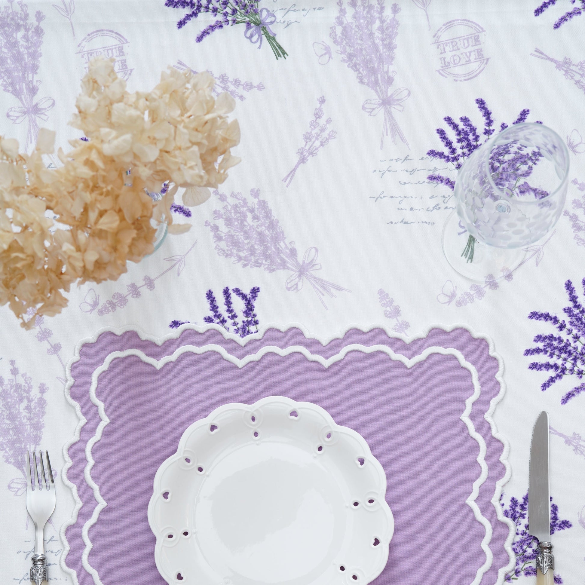 Close-up of the purple lavender bouquet print on the tablecloth, showing detailed motifs and fabric texture