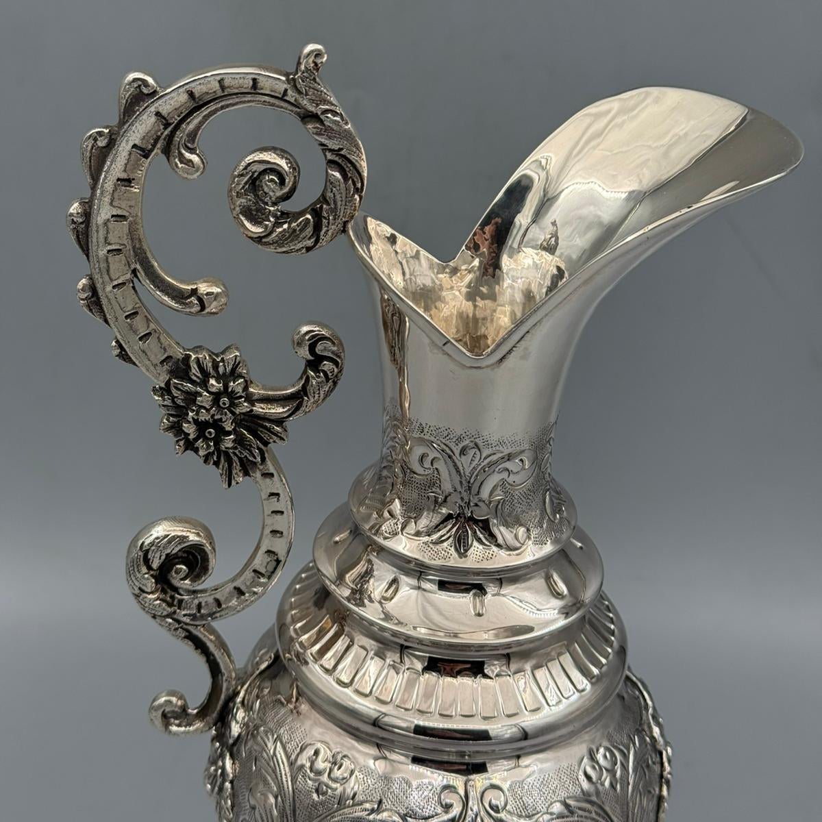 Detail of the magnificent high scroll handle with floral rosettes on silver pitcher by PNR Decor ship from USA