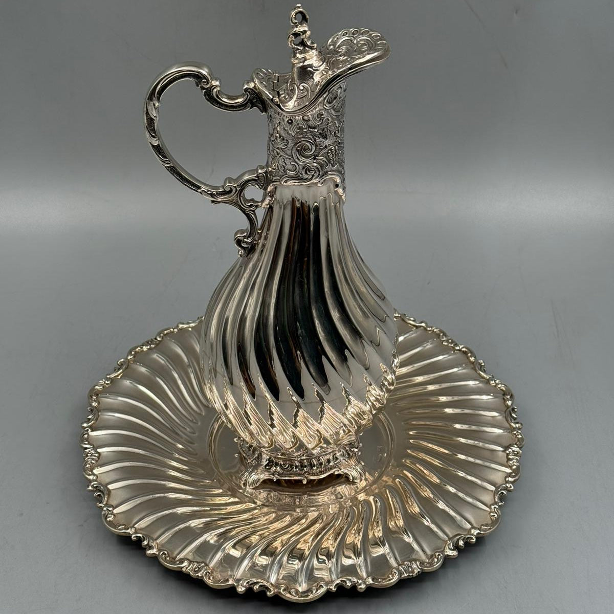 Detail of ornate floral neck and scroll handle on silver pitcher by PNR Decor ship from USA
