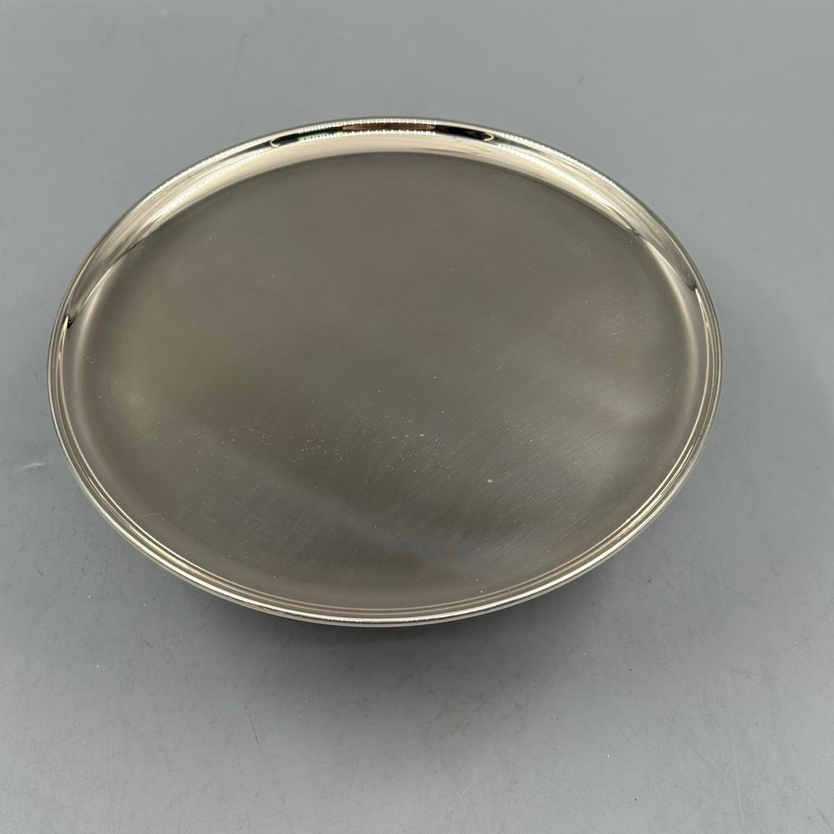 Round silver dessert stand on pedestal base, ideal for cakes, sweets, and appetizers