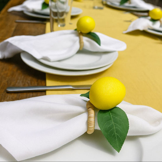 Front view of rustic summer lemon napkin ring with natural rattan base and green leaves.
