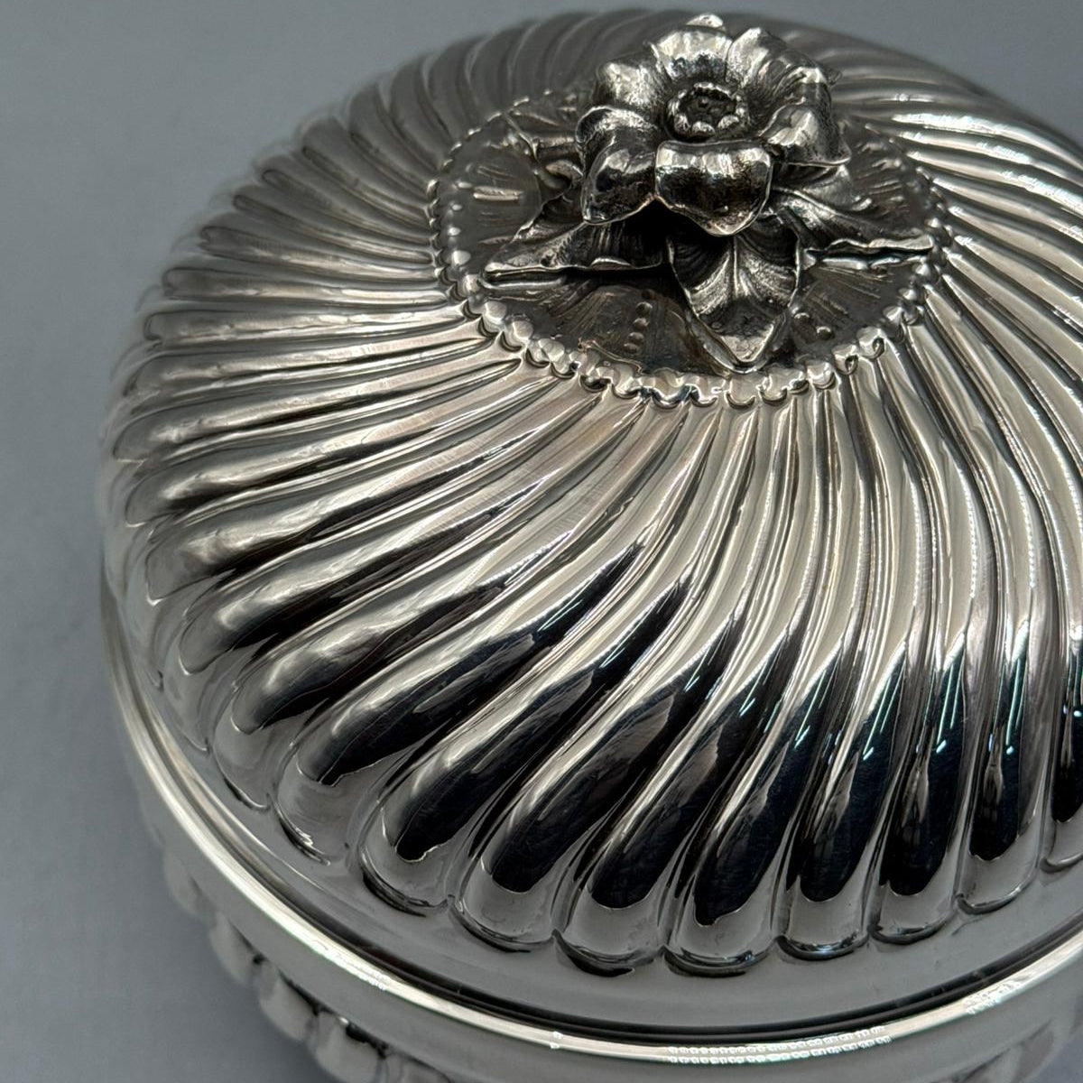 Close-up of the masterfully sculpted silver flower handle atop the Bektashi-style swirled ribbed sterling silver lid.