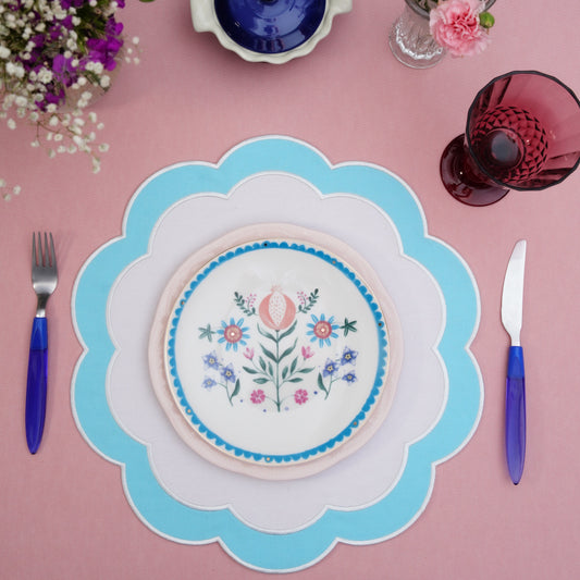 Scalloped fabric placemat displayed on a clean table setting