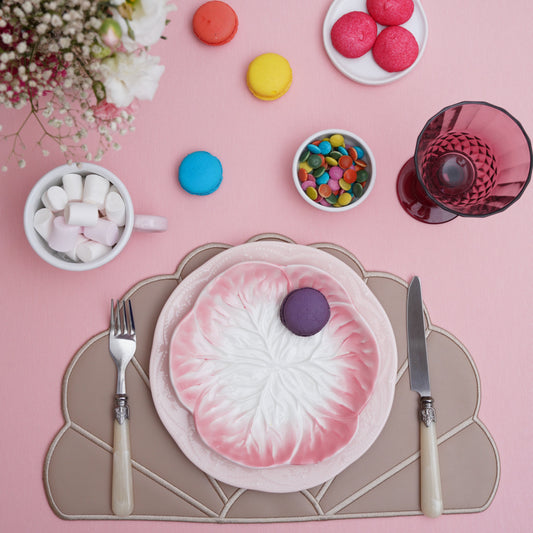 Round scalloped placemat placed on a clean table setting with elegant texture