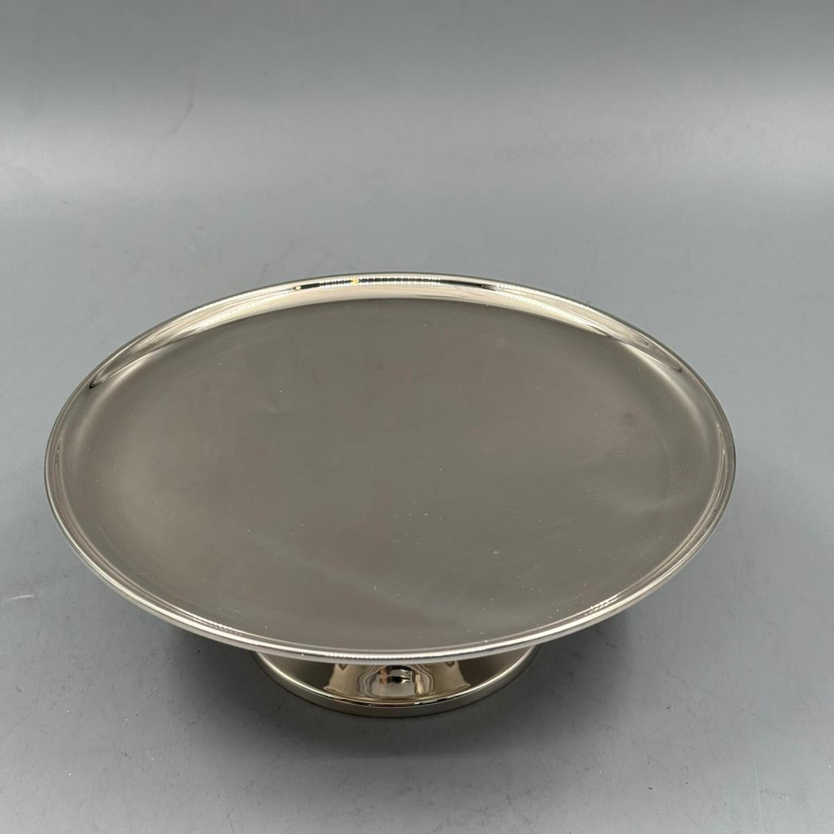 Shiny silver serving tray with elevated base, perfect for cakes and decorative serving