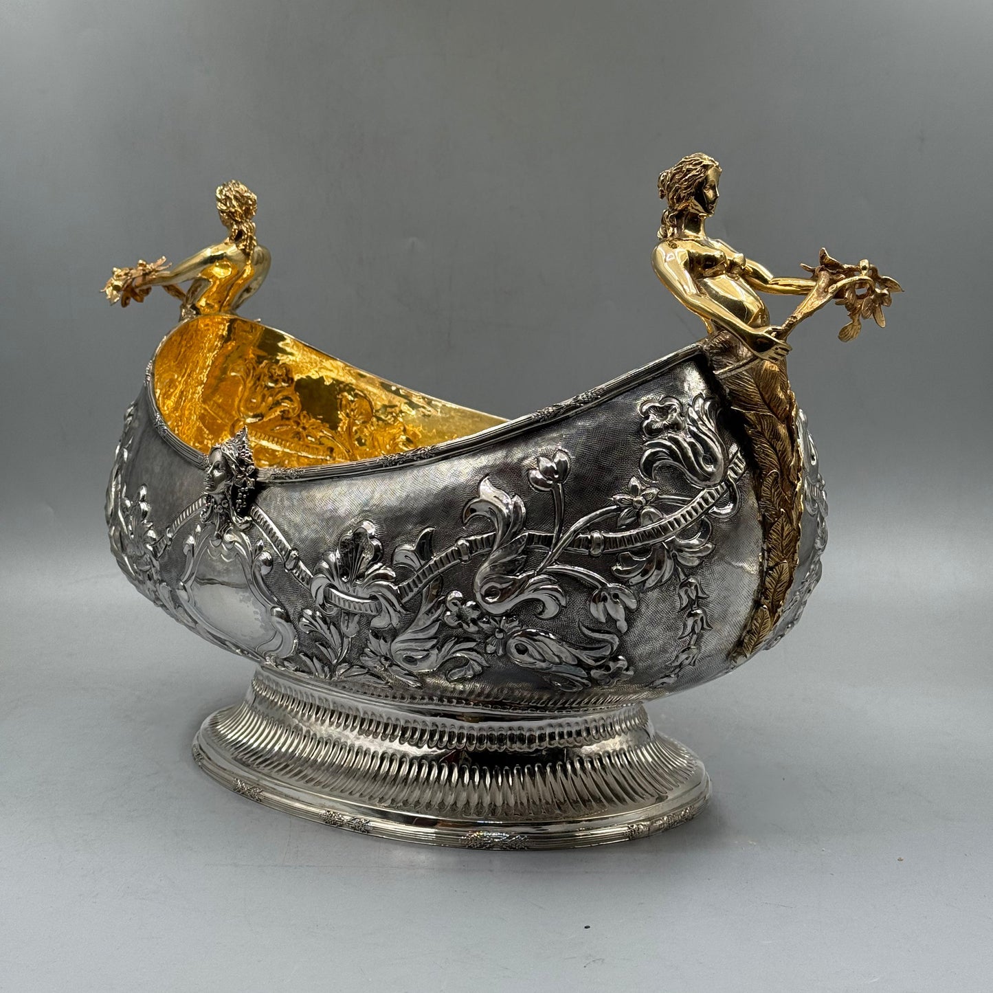 Angled view of luxury silver and gold figural centerpiece for dining table by PNR Decor ship from USA