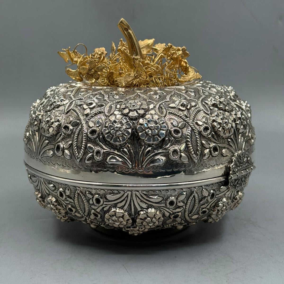 Close-up of the exquisite golden-tone floral vine handle and detailed engraving on the sterling silver candy dish.