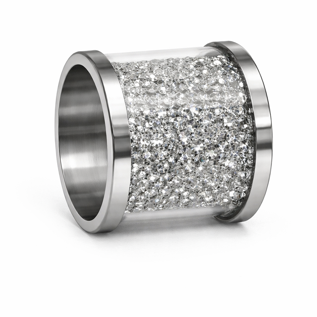 A close-up studio shot of a glamorous cylindrical napkin ring featuring sleek silver metal edges and a wide center band fully encrusted with sparkling clear crystals, set against a pristine white background.