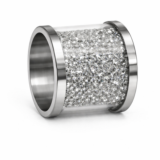 A close-up studio shot of a glamorous cylindrical napkin ring featuring sleek silver metal edges and a wide center band fully encrusted with sparkling clear crystals, set against a pristine white background.