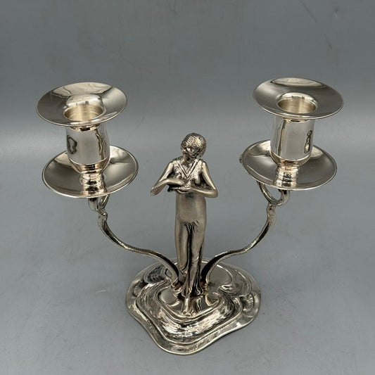 Silver double-arm candlestick with an elegant woman figure holding two candle holders.