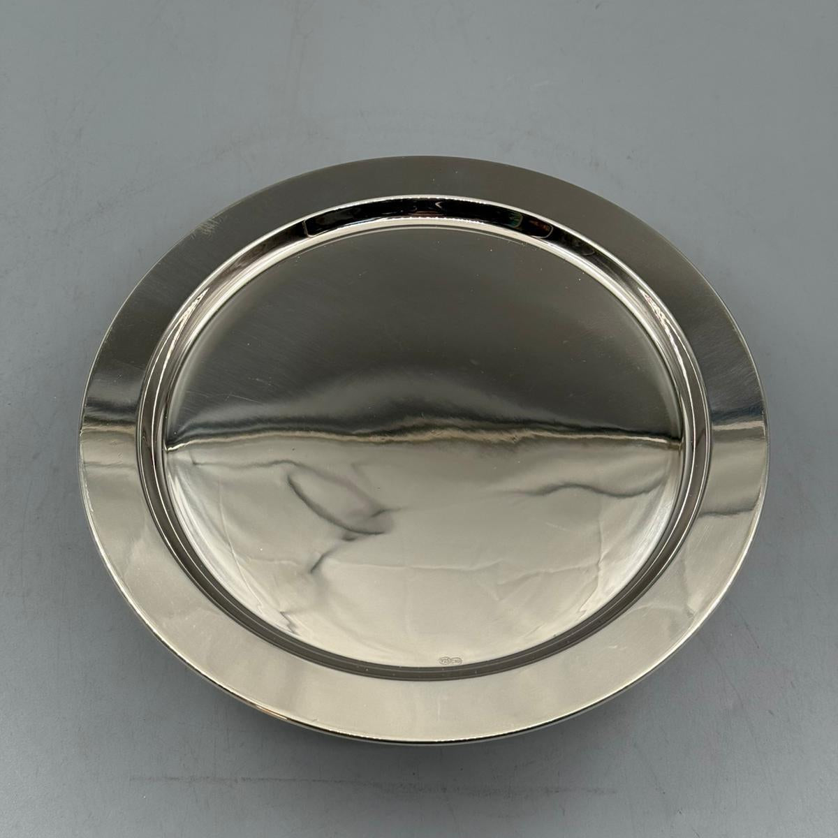 Shiny silver pedestal serving tray with round flat top for cakes and appetizers