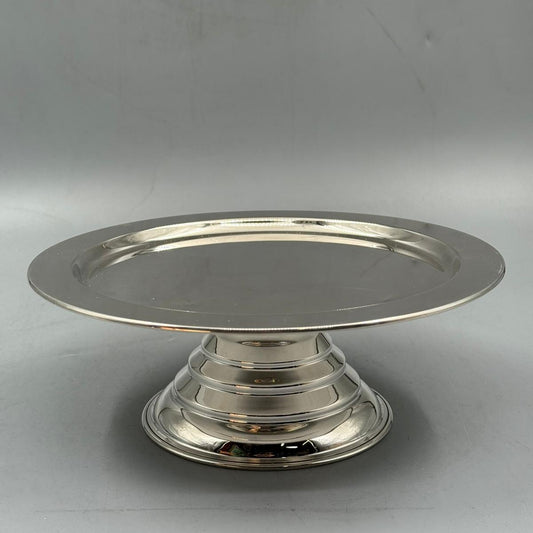 Polished silver round serving plate with smooth surface and classic design