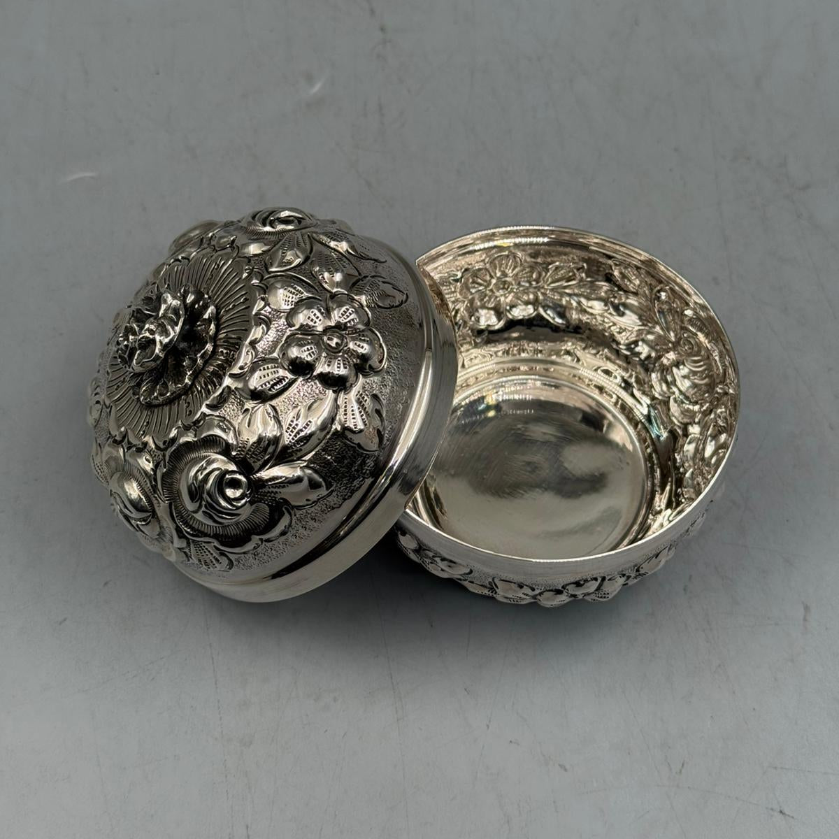 Interior view showing the high-polish finish and the intricate floral embossing visible from the side of the 900 silver statement piece.