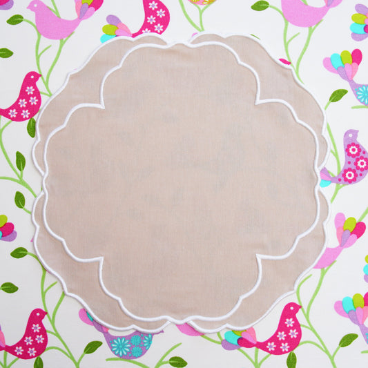 Spring table setting featuring the elegant Sorelle Collection beige and white embroidered placemat for seasonal dining