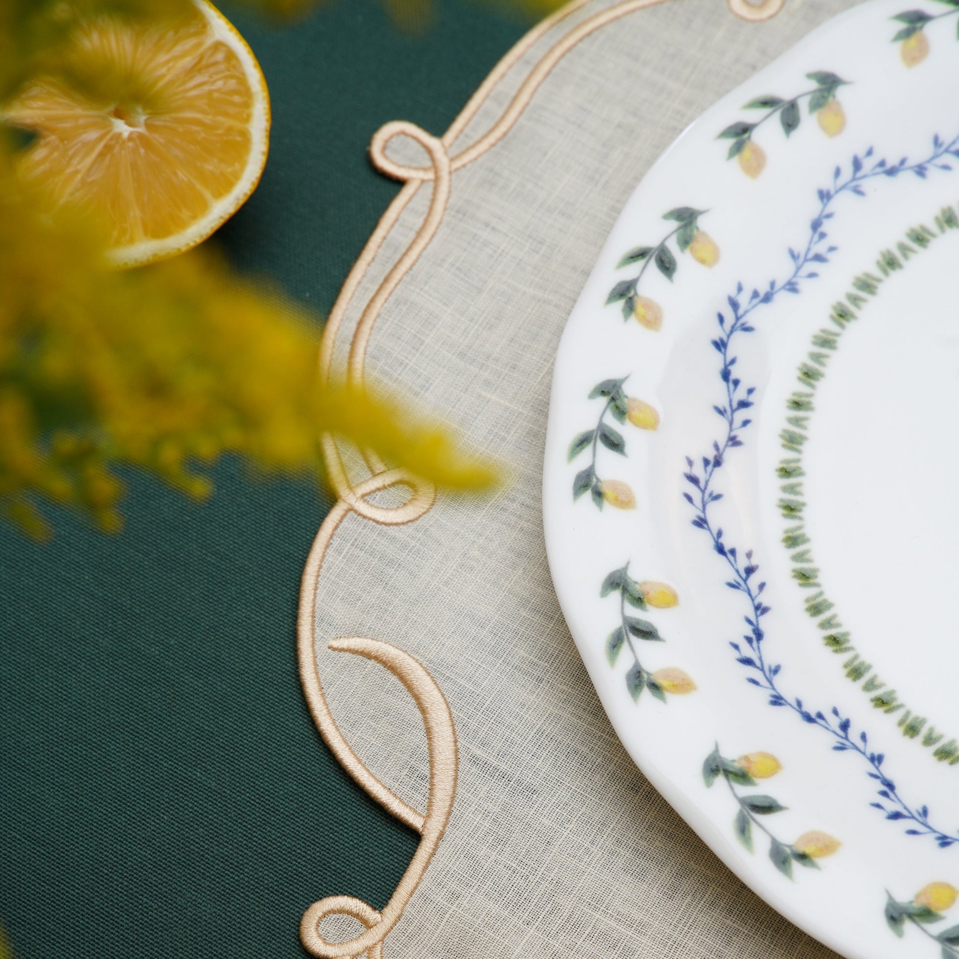 Elegant ivory and gold placemat displayed with neutral tableware