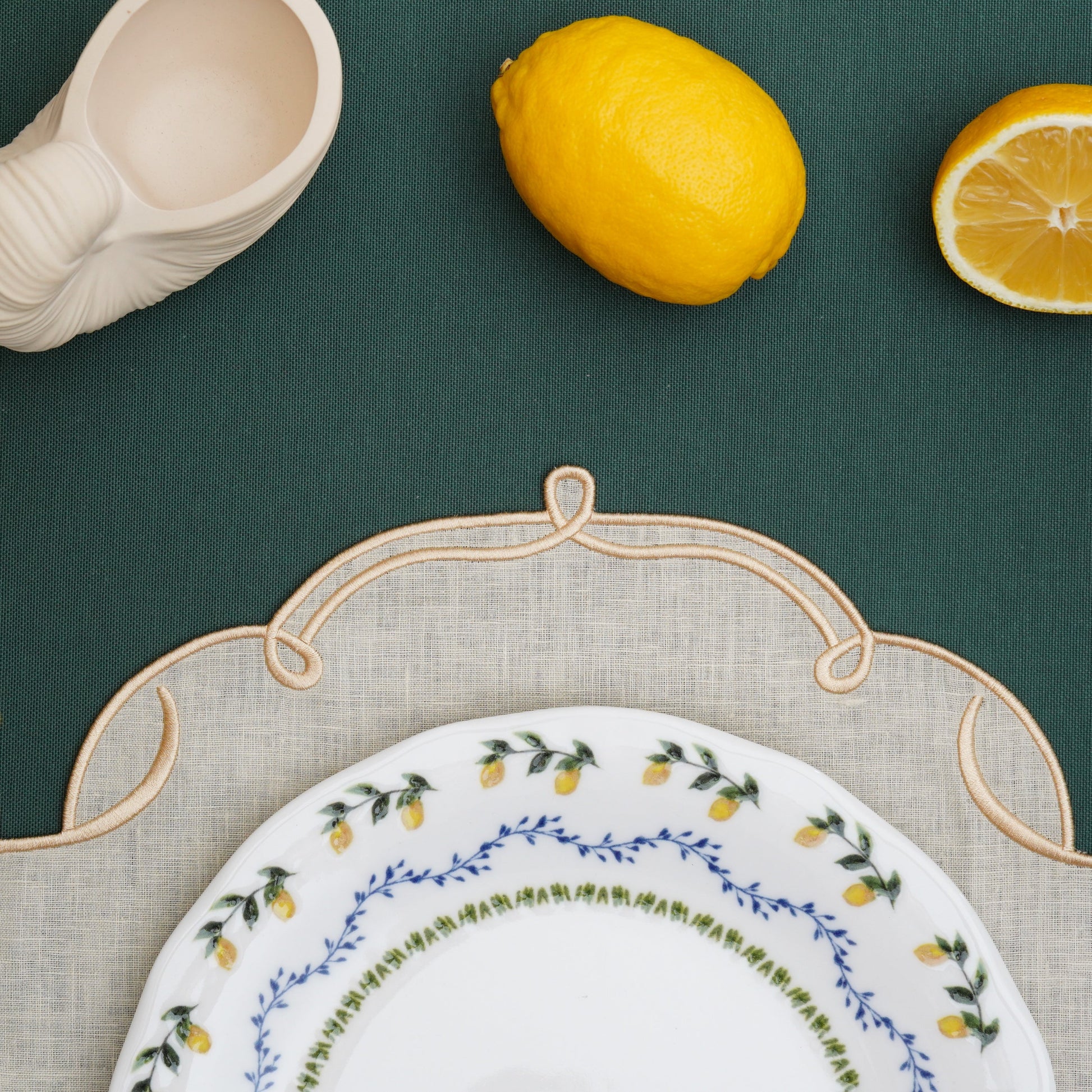 Linen placemat in ivory tone bordered with shimmering gold detail